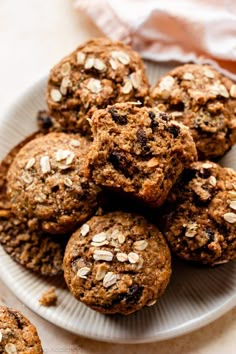 a white plate topped with muffins and oatmeal covered in raisins