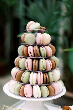 a stack of macaroons sitting on top of a white plate