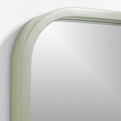 a white mirror mounted to the side of a wall