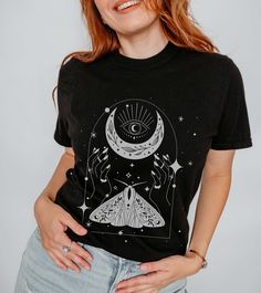 Dive into the mystical realms with our enchanting t-shirt featuring a moon, ethereal moth, and witchy hands. Embrace the magic of the night sky and the secrets it holds with this captivating design. Comfort Colors ▶Unisex Adult Sizing ▶See Our Size Chart For Proper Sizing ▶Rolled sleeves are for styling purposes only ▶Props used in photos are not included with the purchase. ✈ PROCESSING & SHIPPING ✈ Processing Time: 1-7 days Standard Shipping: 2-5 business days after processing time ❤ Returns & Mystical Black Top With Graphic Print, Mystical Black Tops With Graphic Print, Mystical Short Sleeve Top With Graphic Print, Mystical Graphic Print Short Sleeve Top, Mystical Graphic Print Crew Neck Top, Witchy Short Sleeve T-shirt With Graphic Print, Mystical Graphic Print Cotton Tops, Mystical Cotton Tops With Graphic Print, Mystical Cotton Crew Neck T-shirt