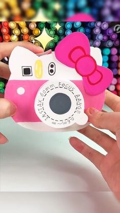 someone is holding up a camera shaped like a hello kitty