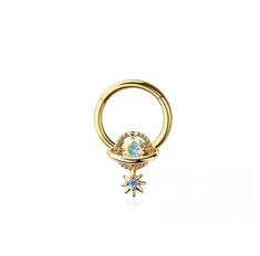 a gold nose ring with an opal stone in the center and a star on top