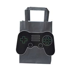 a bag with a video game controller on the front and side, sitting in front of a white background