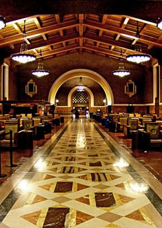 an ornately decorated lobby with chandeliers and tables