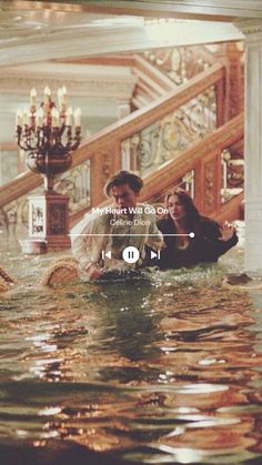 a man and woman sitting on top of a flooded staircase