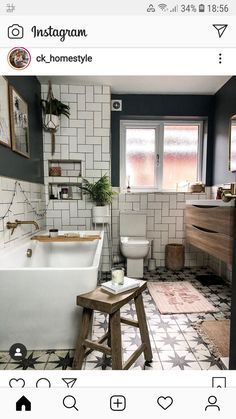 the bathroom is decorated in black and white tiles, with a wooden stool next to the bathtub