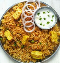 a plate filled with rice, tofu and onions