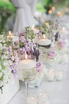 a long table with candles and flowers on it