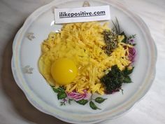 a white plate topped with pasta and an egg