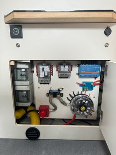 an electrical panel with some wires and other equipment