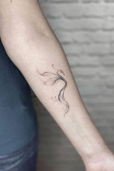 a woman's arm with a tattoo design on the left side of her arm