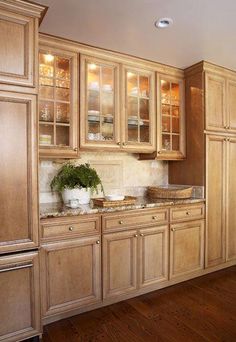 a kitchen filled with lots of wooden cabinets