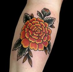 an orange and yellow flower on the arm