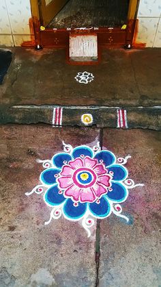 an artistic design painted on the ground in front of a doorway