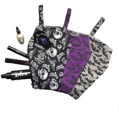 Add some gothic flair to your makeup routine with this coffin shaped cosmetics bag. With a zip up closure, finger handle and a interfaced lining fabric for sturdiness and security of all your favourite on the go makeup products. Or use it as a goth toiletries bag for when you are at festivals and gigs. Made from cotton based and recycled fabrics. This coffin makeup bag features a trick or treat pattern fabric. MAKEUP IN PHOTOS NOT INCLUDED Measurements Length: 11 Inches Width: 8 Inches Zipper - Coffin Bag, Goth Christmas, Gothic Bag, Halloween Sewing, Trick Or, Gothic Gifts, Goth Makeup, Slow Fashion Brands, Cosmetics Bag