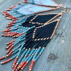 the beaded necklace is made with blue, red and black seed beads on wood