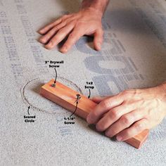 a person is working on a piece of wood that has been placed on the floor