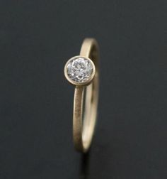 a gold ring with a diamond on it