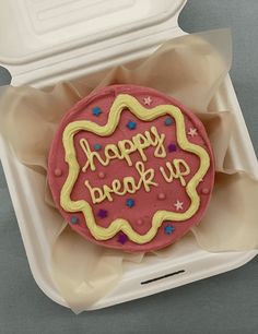 a decorated cookie in a plastic container