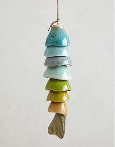 a multi colored bird feeder hanging from a wire