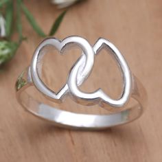 Two interlocking hearts are twice as nice. Presented by Komang Budiarta this charming cocktail ring is perfect for the true romantic. Balinese artisans use sterling silver to create the slender band hand crafting an openwork heart motif that shines in a polished finish. Silver Couple Promise Rings For Mother's Day, Elegant Sterling Silver Couple Rings For Valentine's Day, Silver Couple Rings For Valentine's Day Anniversary, Heart-shaped Sterling Silver Ring For Anniversary, Silver Sterling Heart Ring For Anniversary, Sterling Silver Double Heart Ring For Anniversary, Silver Double Heart Ring For Mother's Day, Silver Heart-shaped Couple Rings For Anniversary, Sterling Silver White Gold Heart Ring For Anniversary