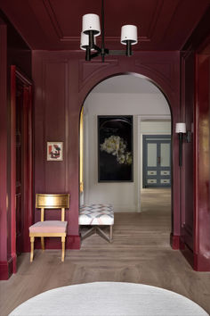 a hallway with red walls and wooden floors