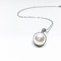 Our Unique Pendant Is Designed With White Freshwater Pearl , Cubic Zirconia And 925 Sterling Silver. You Can Wear It All Day Long. Jewelry : Pearl Pendant Pearl Type : Freshwater Pearl Pearl Grade : AAA+ Pearl Luster : High Pearl Body : Clean Pearl Shape : Round/ *Button Pearl Nacre : All (100% nacre)  Necklace Length : 18 Inches = 45.7cm  Pearl Color : *White/Pink/Gray/Black Pearl Size: Approx  10-11mm / 11-12mm Clasp : 925 Sterling Silver Metal: Sterling silver Sterling Silver Chain: 18 inches Size Of Pendant : Approx  Length 20mm x 15mm Width *Nice Jewelry Box Wrap Thanks For Choosing Blest Jewellery :)   Blest Jewellery *Professional Jewellery Design  (since 2010)  Website: http://blestjewellery.yolasite.com online shop : www.etsy.com/shop/blestjewellery Facebook /Instagram search : bl Jewellery Pearl, Jewelry Pearl, Round Button, Professional Jewelry, White Freshwater Pearl, Pearl Types, Unique Pendant, White Colour, Jewelry Companies