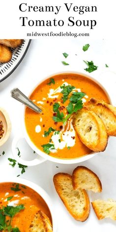 two bowls of creamy vegan tomato soup with bread on the side