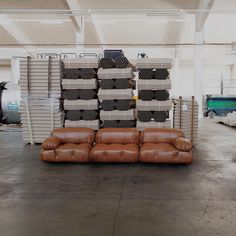 the couches are stacked on top of each other in an industrial area with lots of storage