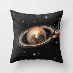 a pillow with a disco ball in the middle of it and stars on the background