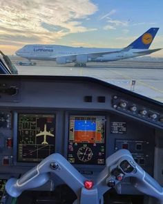 the view from inside an airplane cockpit at sunset