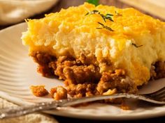 a piece of shepherd's pie on a plate with a fork