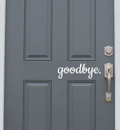 a gray door with the word hello written on it and a metal handle that says hello