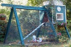 an outdoor structure with a clock on the side and plants growing out of it's sides