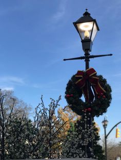 a christmas wreath on top of a street light