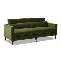 a green couch sitting on top of a white floor