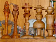 wooden chess pieces are lined up on a shelf