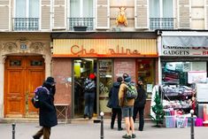 people are standing in front of a store