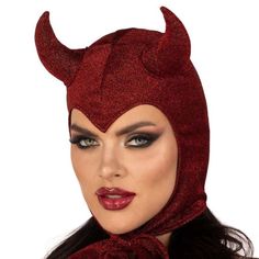 a woman wearing a red devil mask with horns