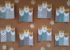 several pieces of paper are arranged in the shape of crowns and stars on a bulletin board