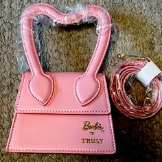 For Sale: A Brand New Limited Edition Barbie X Truly Pink Mini Purse In 100% Vegan Leather And The Doll’s Signature Shade Of Pink.Done With Authorization From Mattel. Features The Barbie And Truly Labels On The Front Roasted In Gold. Heart Shaped Handheld Handle And Also A Detachable Shoulder Strap Rolled Up And Tucked Inside So It Can Be Worn Cross Body. 5.7x4.3x2 Inches So Adorable. Strap Still Sealed In Plastic And Comes In Original Plastic Bag. Only Out To Take Photos. Did Notice A Teeny Tin Truly Skincare, Pink Mini Purse, Barbie Purse, Barbie Bag, Limited Edition Barbie, Barbie Halloween Costume, Rainbow Purses, Crossbody Clutch Purse, Bday Wishlist