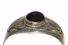 an antique silver ring with a black stone