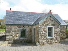 an old stone house with a slate roof