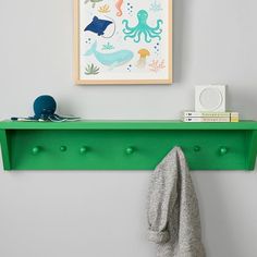 Add a pop of color and brilliant organization to your little one's wall with this vibrant shelf. Crafted of solid wood, it offers five pegs for hanging coats and backpacks, plus a shelf for grab-and-go items. KEY PRODUCT POINTS Handcrafted from solid poplar wood and finished with acrylic latex paint in a variety of vibrant colors (each sold separately). Pegs are made from 100% birch wood. BPA-, Phthalate- and Lead-free. Mounting hardware is included. Domestic. Shelf With Pegs, Shelf And Hooks, Kids Bathroom Organization, Lilac Nursery, Blue Shelves, Shelf Hooks, Storage Bench Seating, Kids Shelves, Clever Organizer