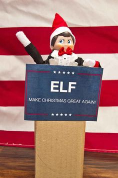 an elf holding a sign that says make christmas great again