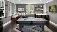 a pool table in the middle of a living room