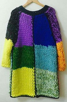 a multicolored sweater hanging on a wooden hanger