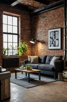 an industrial living room with brick walls and exposed ceilings, leather couches, wooden coffee table, and potted plants