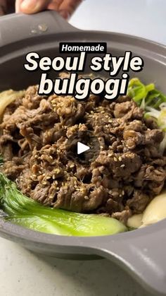 a bowl filled with meat and vegetables on top of a table