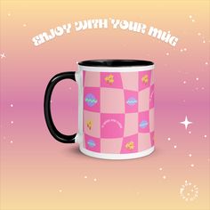 a pink and black coffee mug sitting on top of a purple background with the words, enjoy